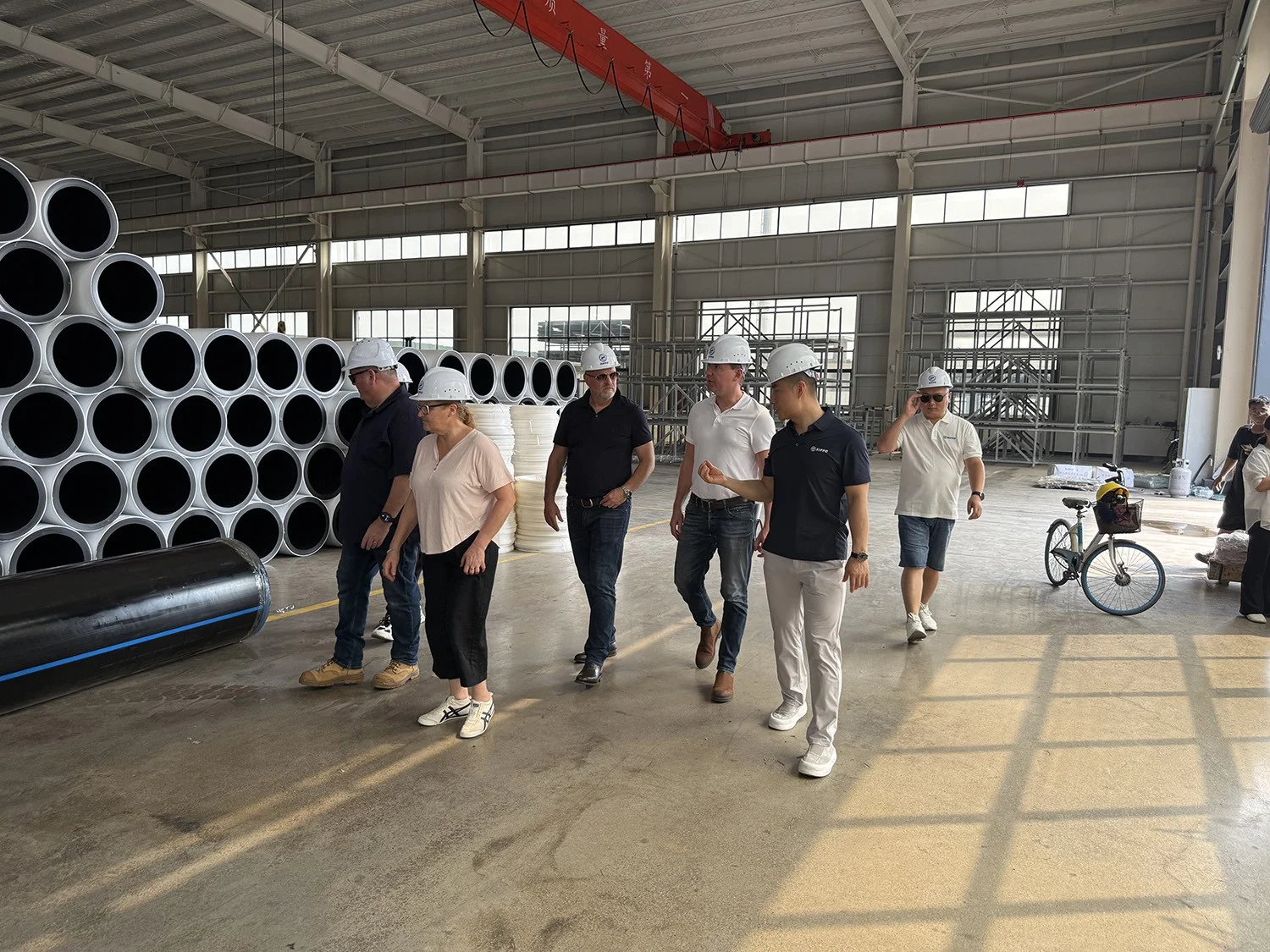 German customers touring the White Co-Extruded HDPE Pipe storage area