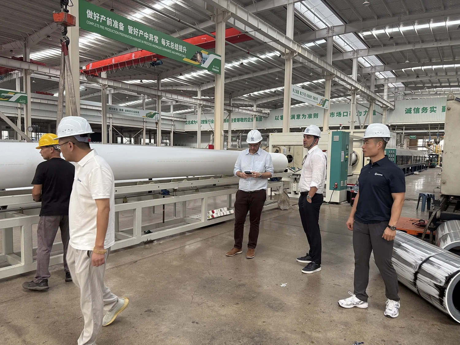 Spanish specialists observing White Co-Extruded HDPE Pipe on the SIFFO production line