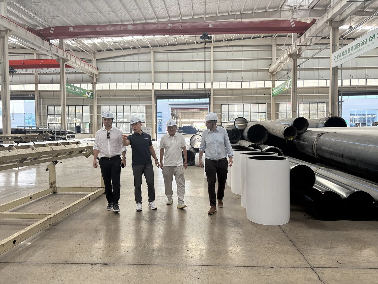  Spanish client reviewing White Co-Extruded HDPE Pipe sections and finished HDPE pipes in the SIFFO workshop