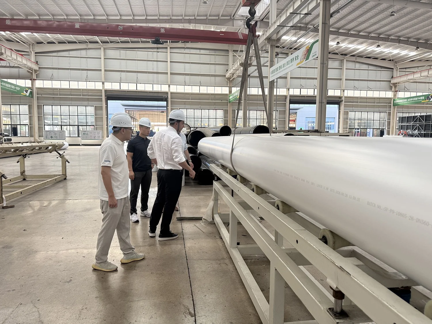 Spanish specialists observing White Co-Extruded HDPE Pipe on the SIFFO production line